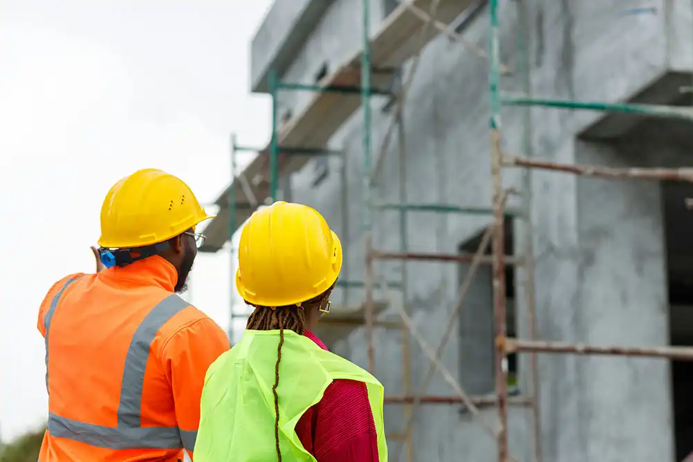 construction workers in front of a concrete structure